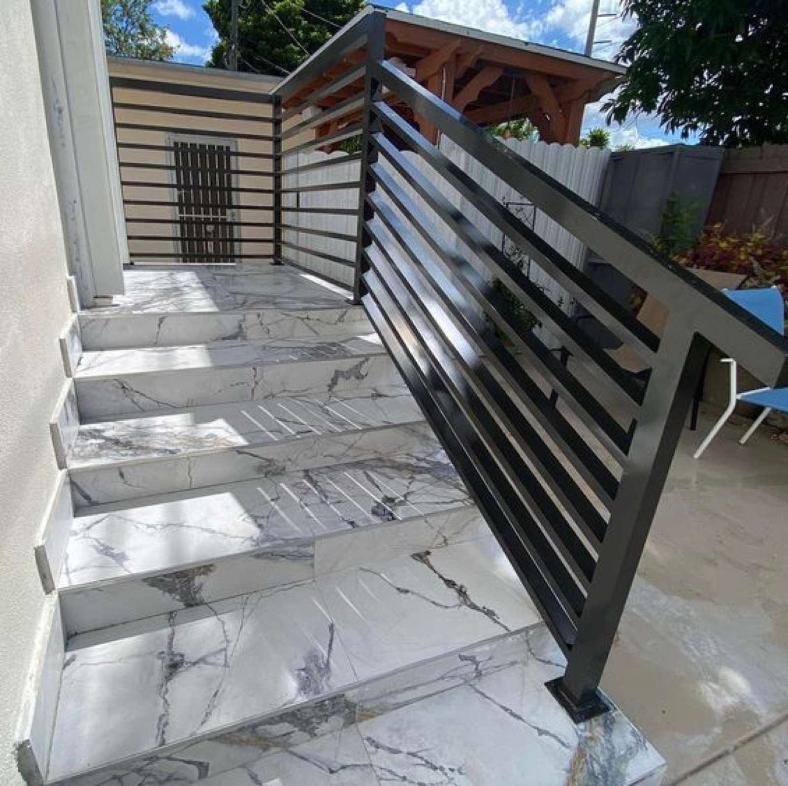 Modern railing on marble staircase