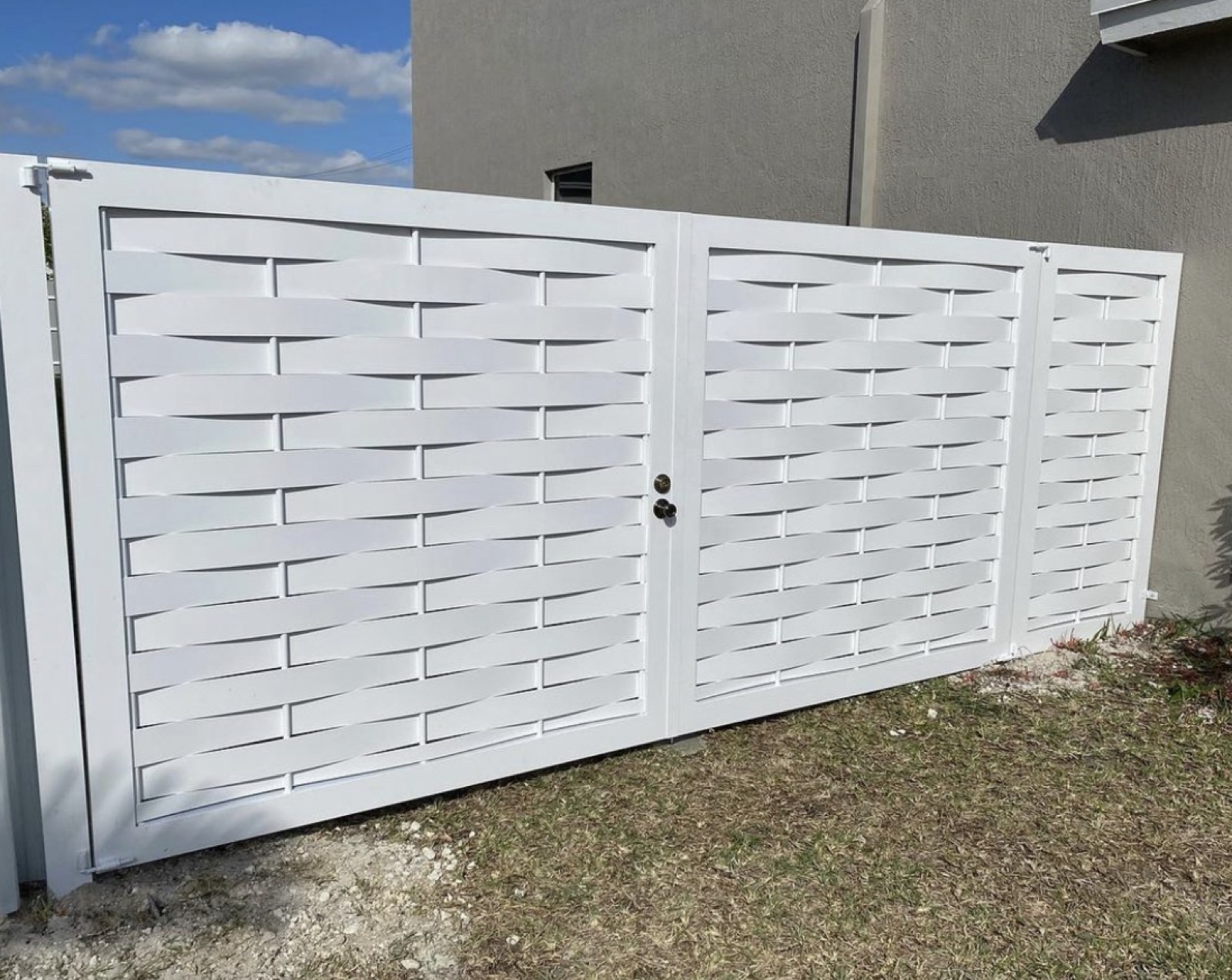 White woven-style aluminum driveway gate