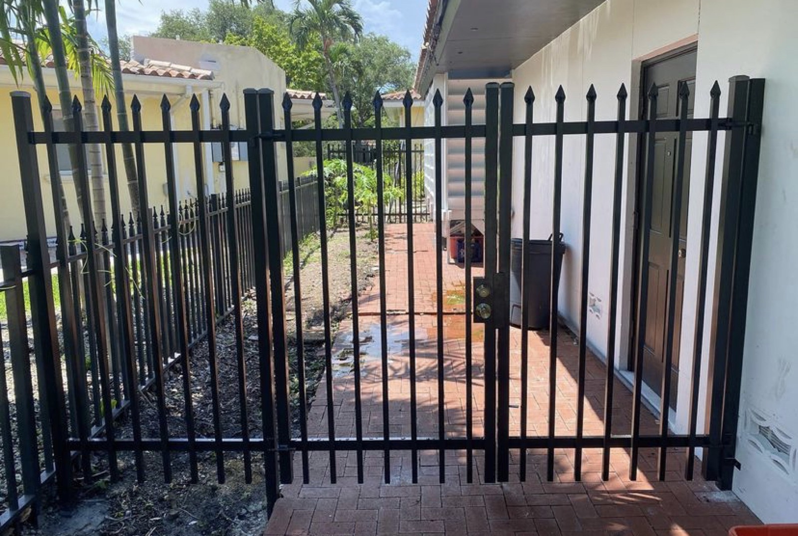 Black aluminum picket fence along walkway